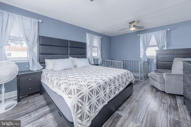 bedroom with ceiling fan and wood-type flooring