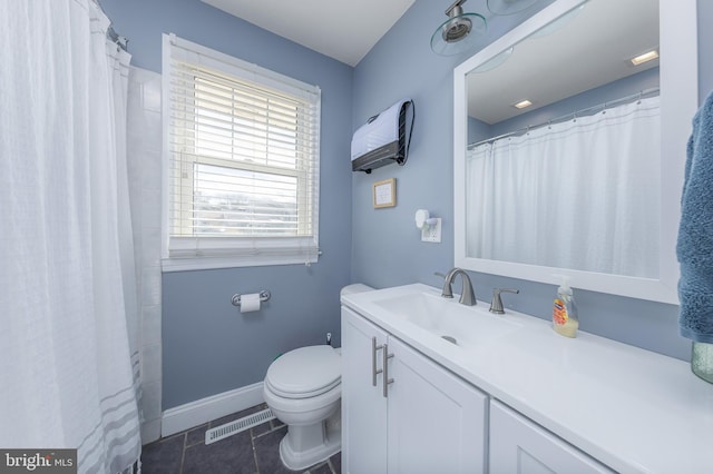 bathroom with vanity, tile patterned flooring, and toilet