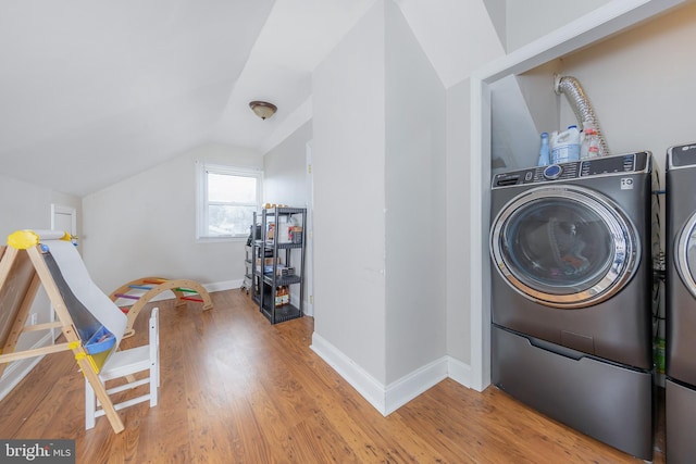 laundry area featuring hardwood / wood-style floors and washing machine and clothes dryer