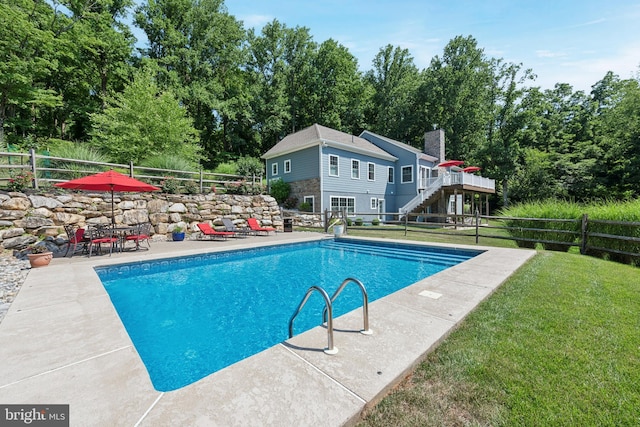 view of swimming pool with a fenced in pool, a lawn, stairway, a patio area, and fence