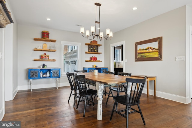 dining space featuring baseboards, dark wood finished floors, a notable chandelier, and recessed lighting