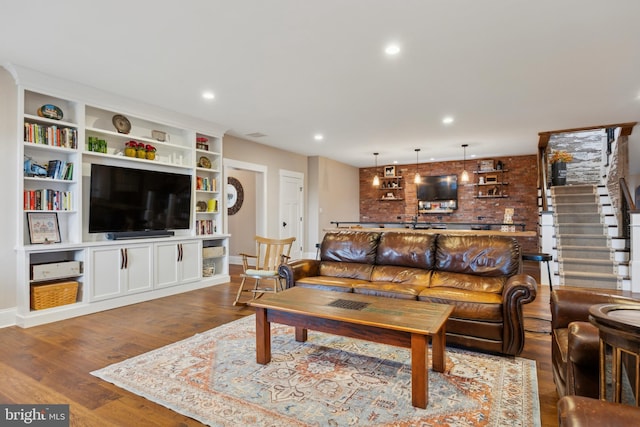 living area featuring stairway, wood finished floors, and recessed lighting