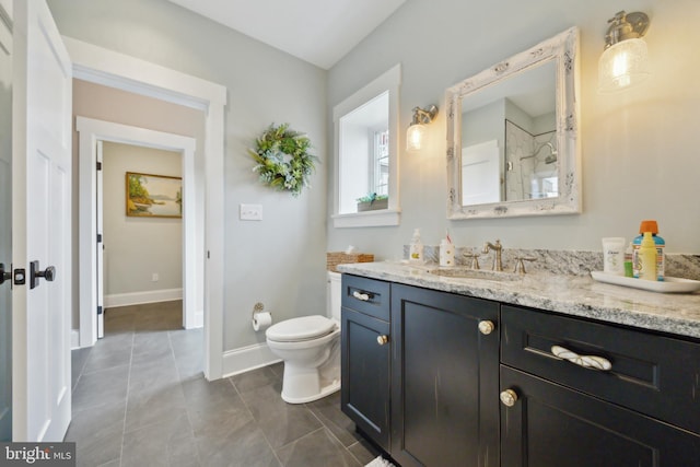 full bathroom with baseboards, vanity, toilet, and tile patterned floors