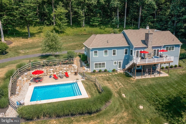 exterior space with a lawn, a patio, stairs, fence, and a wooden deck