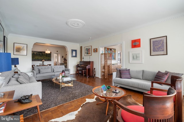 living room with ornamental molding and dark parquet flooring