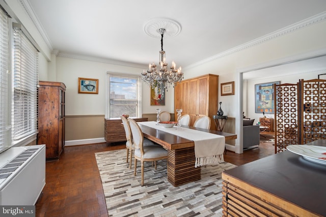 dining room with crown molding and a chandelier