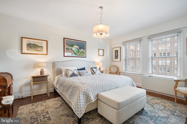 bedroom with dark hardwood / wood-style flooring