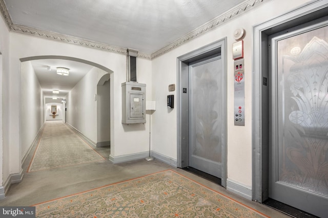 corridor featuring elevator and concrete floors