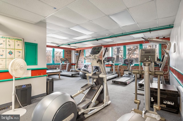 exercise room with a paneled ceiling