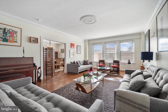 living room featuring crown molding, parquet floors, and an inviting chandelier