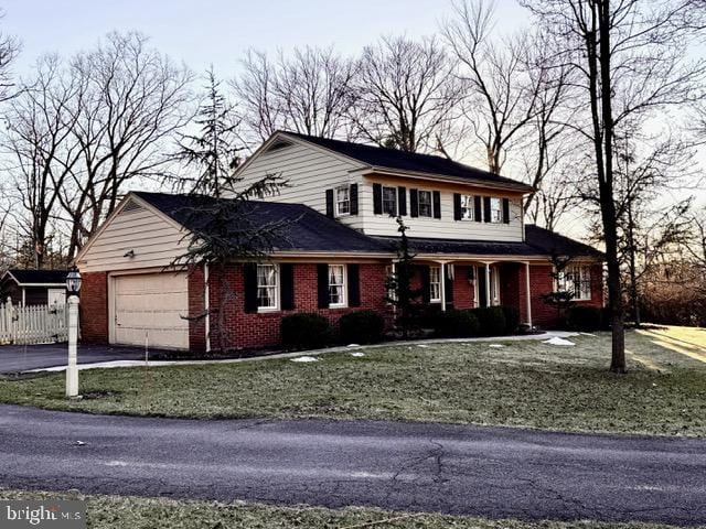 view of property featuring a front lawn and a garage