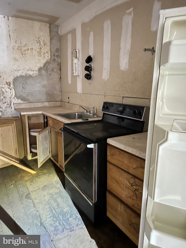 kitchen featuring range with electric cooktop and sink