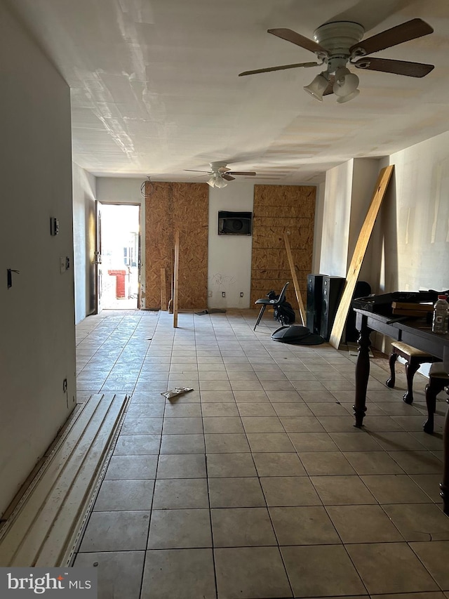 misc room with tile patterned floors and ceiling fan