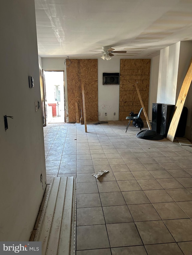 tiled empty room with ceiling fan