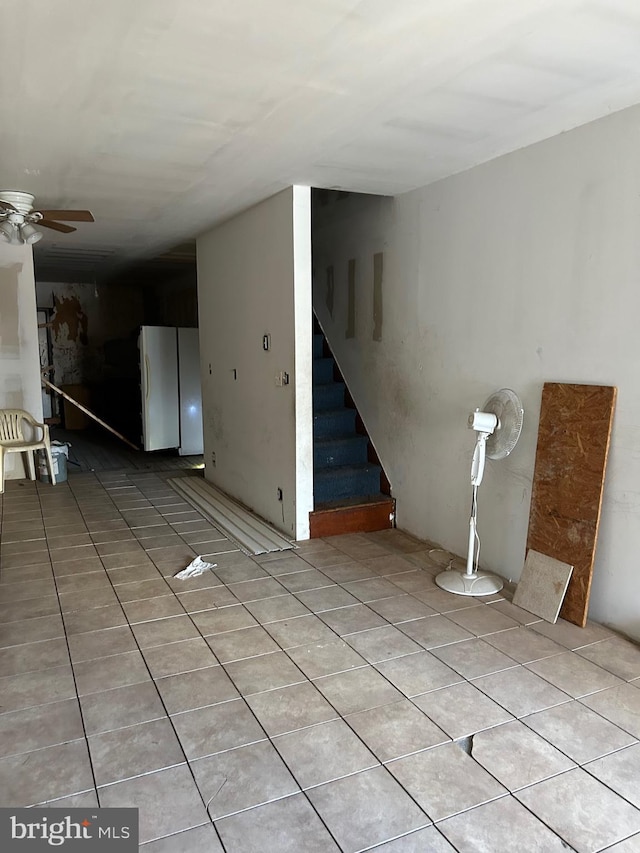 interior space with ceiling fan