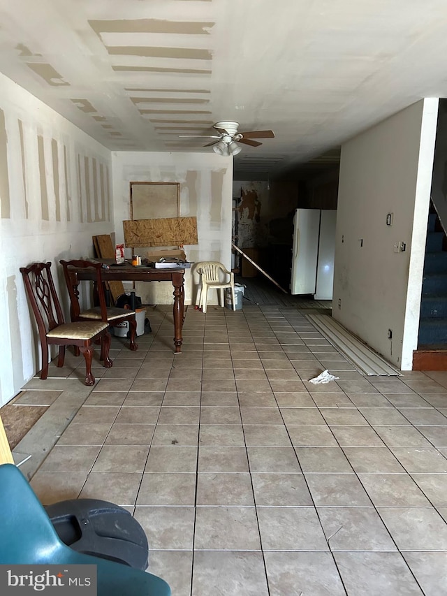 dining area with ceiling fan and tile patterned flooring