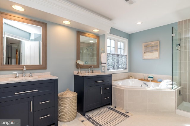 full bathroom with tile patterned flooring, two vanities, a bath, and a sink