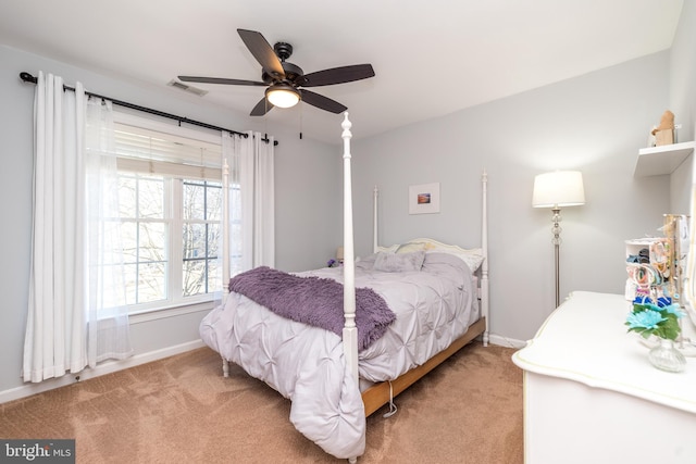 bedroom with visible vents, light colored carpet, a ceiling fan, and baseboards