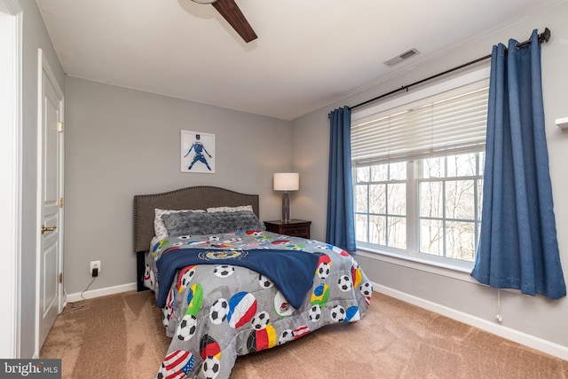 bedroom featuring visible vents, baseboards, a ceiling fan, and carpet flooring