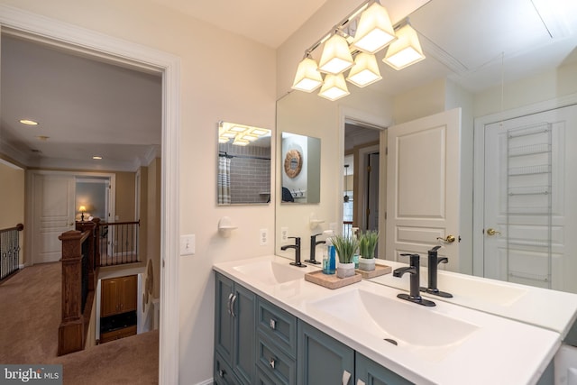 bathroom with double vanity, recessed lighting, and a sink