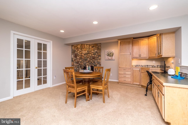 dining space with recessed lighting, french doors, and light colored carpet