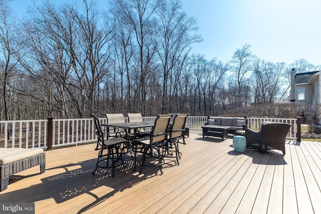 deck with an outdoor living space and outdoor dining area