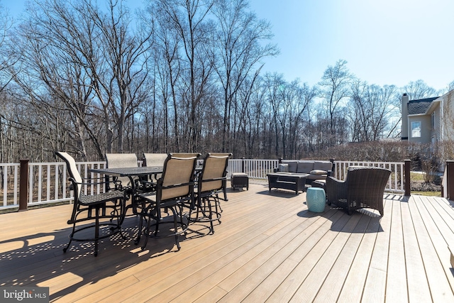 wooden deck featuring outdoor dining area and an outdoor hangout area