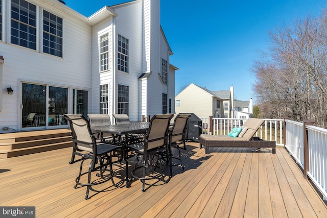 wooden terrace with outdoor dining space