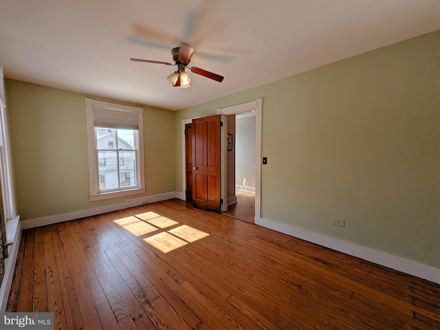 unfurnished bedroom featuring light wood-style floors, ceiling fan, and baseboards