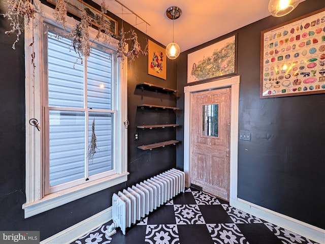 mudroom featuring baseboards and radiator heating unit