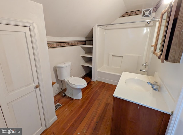 full bathroom featuring toilet, wood finished floors, vanity, visible vents, and vaulted ceiling