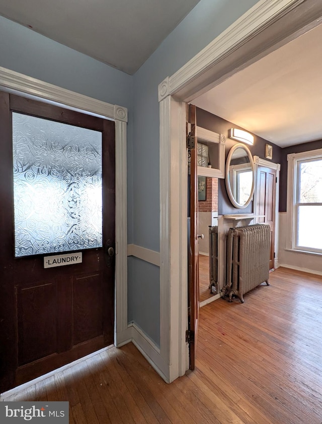 entrance foyer featuring radiator heating unit and light wood-style flooring