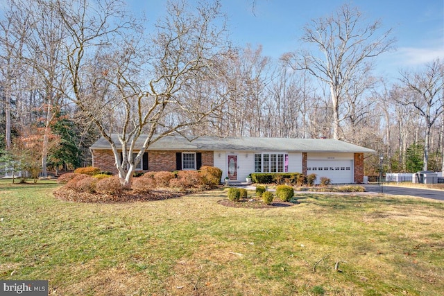 ranch-style house featuring a garage and a front yard