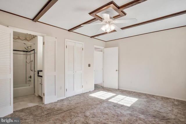 unfurnished bedroom featuring carpet floors, connected bathroom, ceiling fan, and a closet