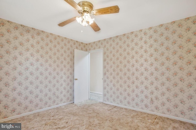 spare room featuring ceiling fan and carpet