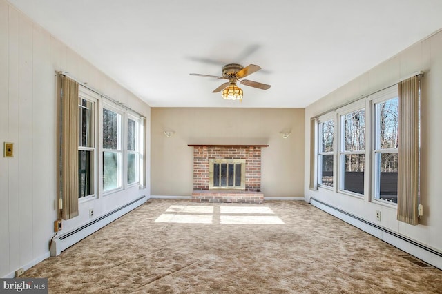 unfurnished living room featuring a baseboard heating unit, carpet floors, and a healthy amount of sunlight