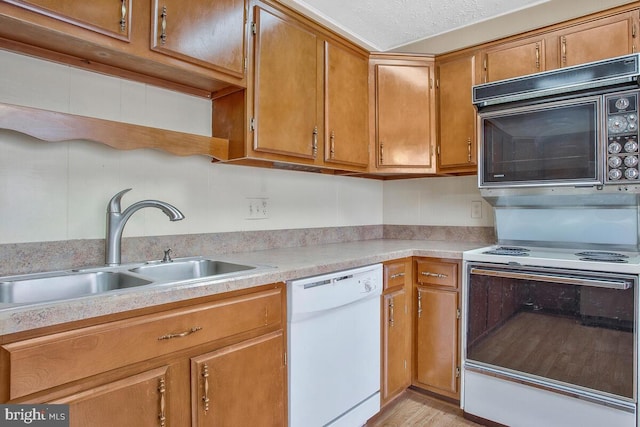 kitchen featuring sink and white appliances