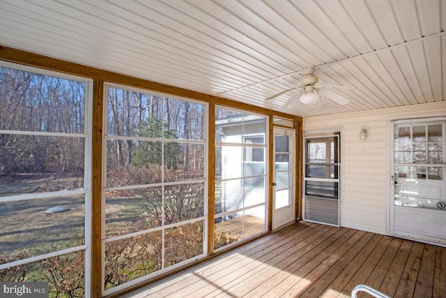 unfurnished sunroom with ceiling fan