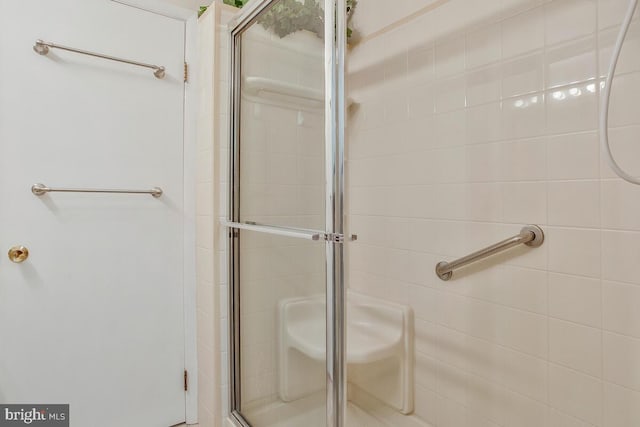 bathroom with a shower with door