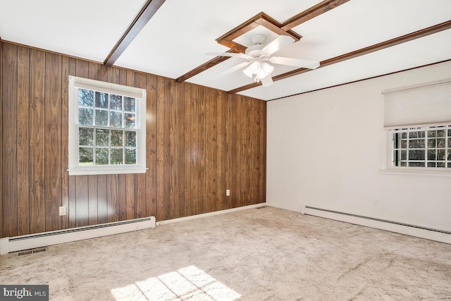 unfurnished room featuring baseboard heating, wooden walls, and carpet floors