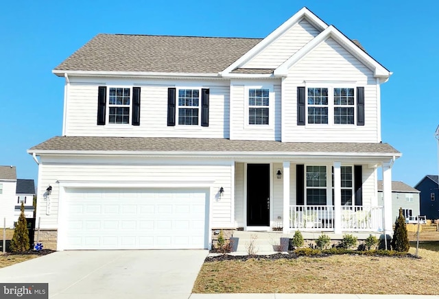 traditional-style home featuring driveway, covered porch, a shingled roof, and a garage