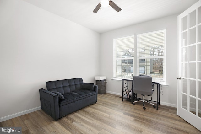 office with a ceiling fan, baseboards, and wood finished floors