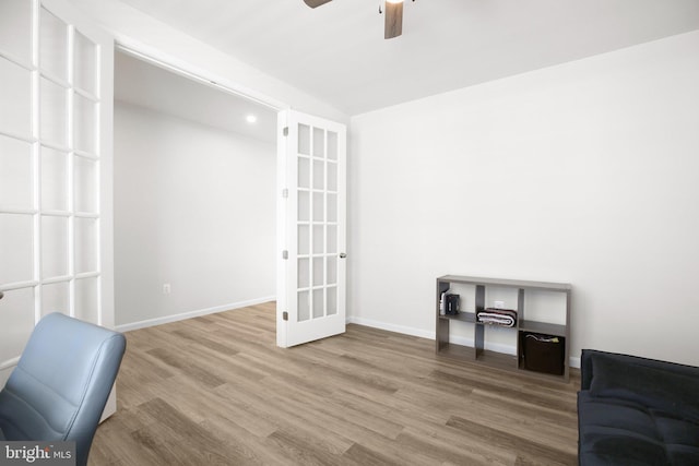 sitting room with ceiling fan, french doors, wood finished floors, and baseboards