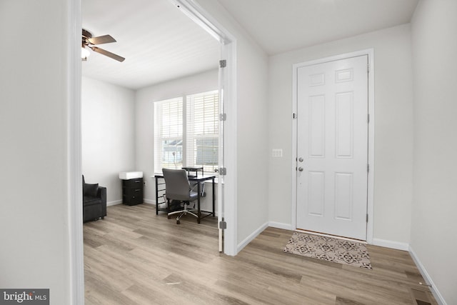 entryway featuring a ceiling fan, baseboards, and wood finished floors