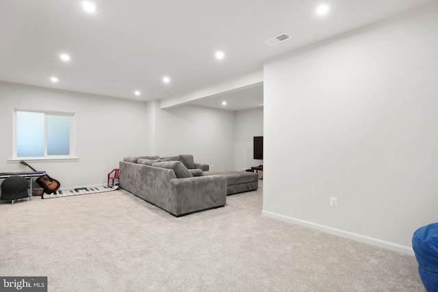 carpeted living area with visible vents, baseboards, and recessed lighting