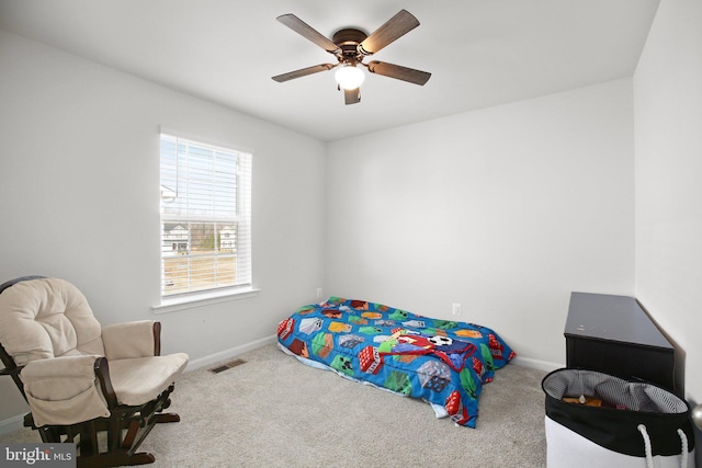 carpeted bedroom with baseboards, visible vents, and ceiling fan