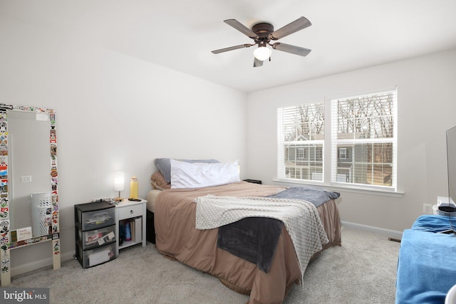 carpeted bedroom with a ceiling fan and baseboards