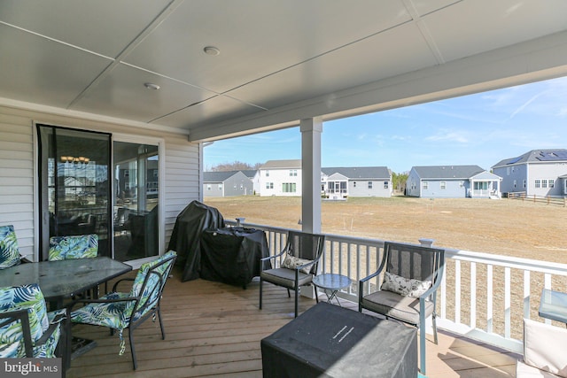 wooden deck with grilling area and a residential view