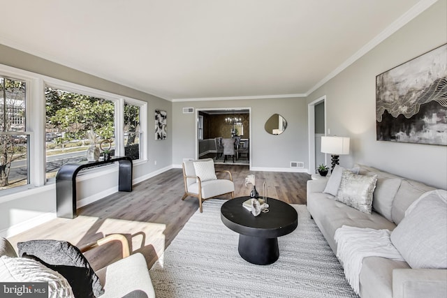 living room with wood-type flooring and ornamental molding