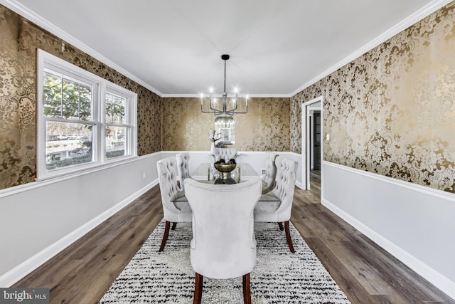 dining space featuring ornamental molding, a notable chandelier, and dark hardwood / wood-style flooring